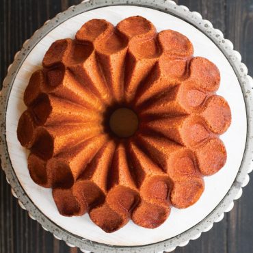 Top view baked vanilla Crown Bundt cake on serving plate