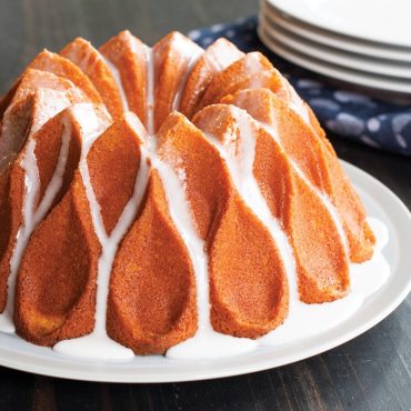 baked Crown cake with white glaze on serving plate