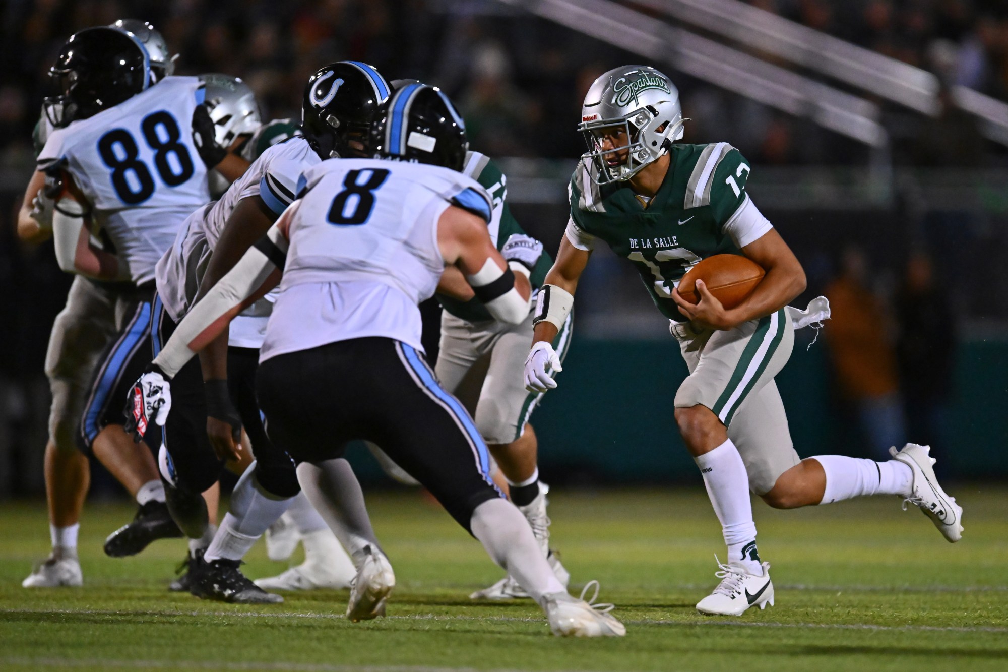 De La Salle quarterback Toa Faavae (13) runs for yardage against Clovis North in the second quarter of their NorCal Division I-AA regional championship game at De La Salle High School in Concord, Calif., on Friday, Dec. 1, 2023. De La Salle defeated Clovis North 41-0. (Jose Carlos Fajardo/Bay Area News Group)