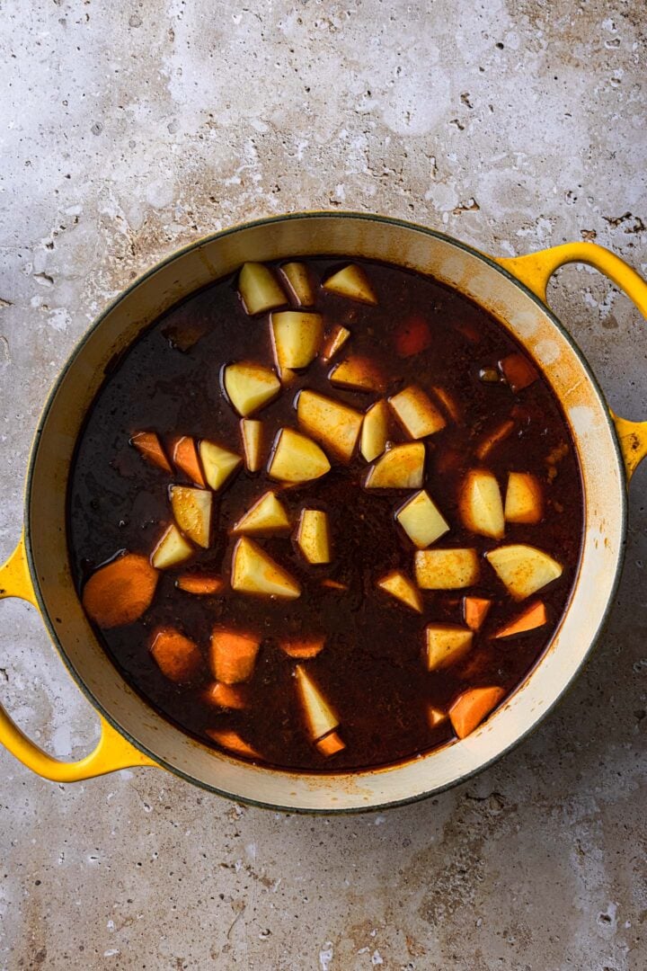 Adding the carrots and potatoes.