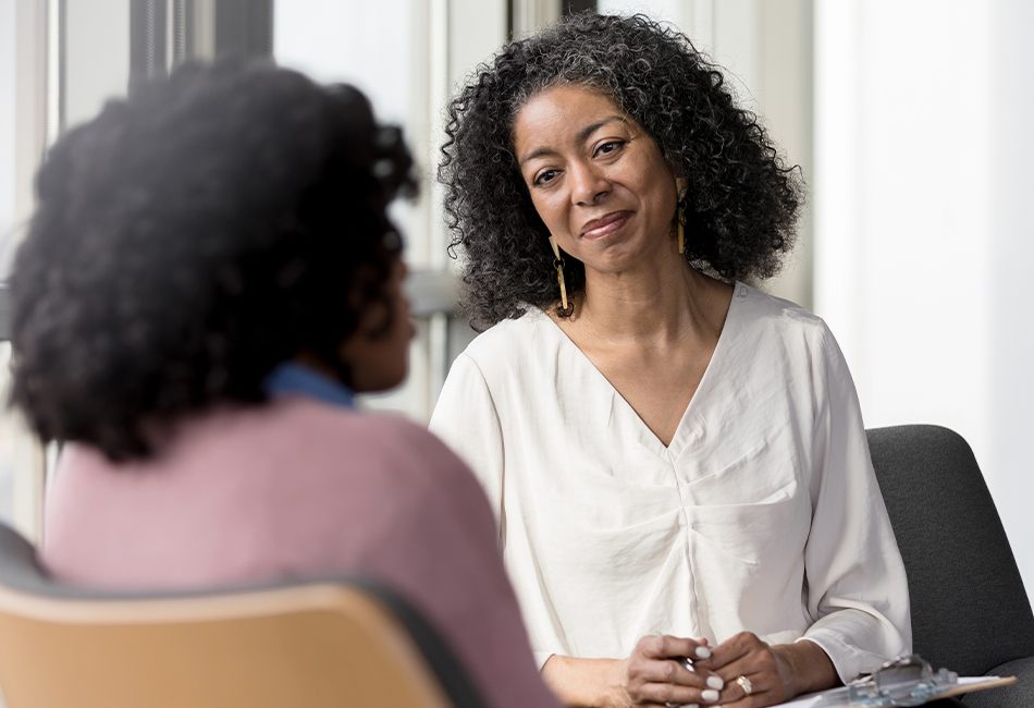 Patient Ambassador Services two women sitting across each other