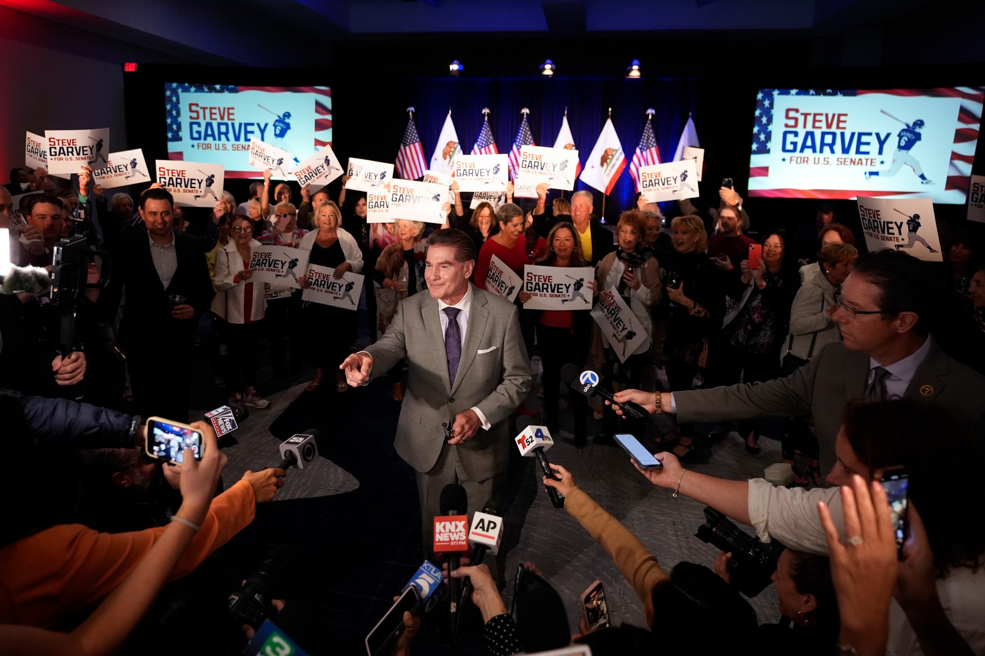 Republican U.S. Senate candidate Steve Garvey talks to reporters in front of supporters, Tuesday, March 5, 2024, in Palm Desert, Calif. (AP Photo/Gregory Bull)