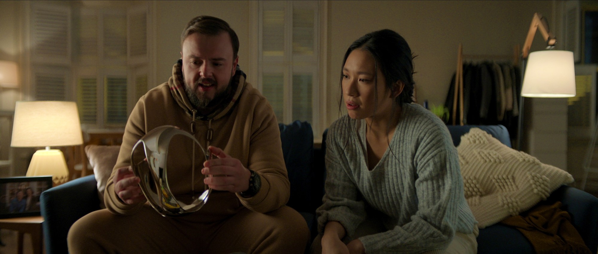 John Bradley's Jack examines an advanced virtual-reality headset that's been given to Jess Hong's Jin in "3 Body Problem." (Courtesy of Netflix)