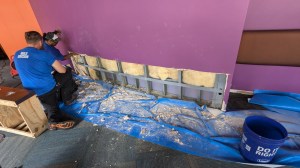 Workers cut into the wall of the Fringe ArtSpace lobby in search of water damage after a flood. Now that the water is gone, the repairs can begin. (Courtesy Orlando Fringe)