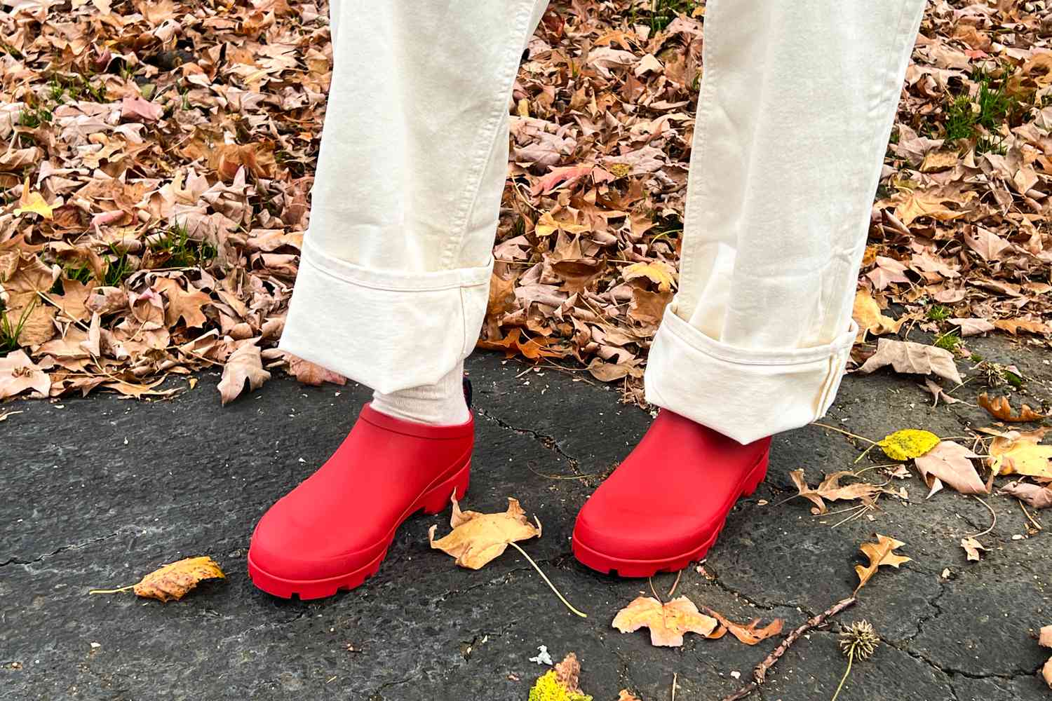 A person wears the SeaVees Bodega Clogs outside while walking in leaves