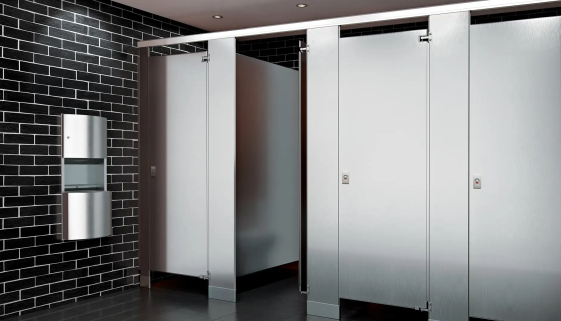 ASI Stainless Steel Toilet Partitions in a Black Titled Bathroom with a Stainless Steel Paper Towel Dispenser and Trashcan on the wall