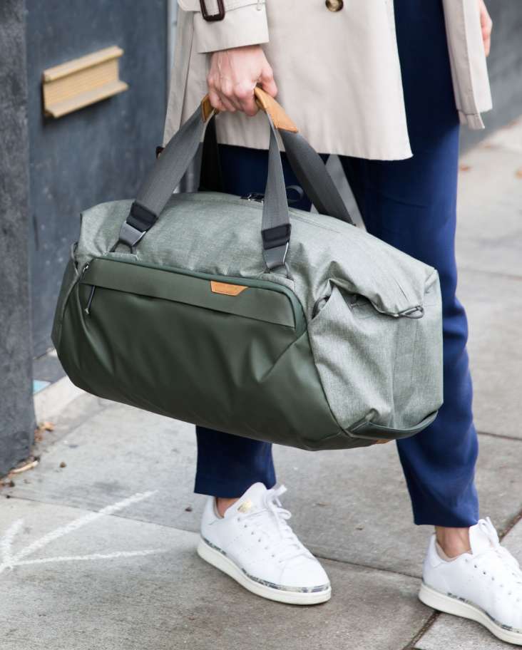 Woman Carrying Duffels 