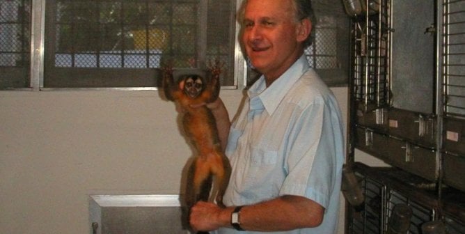 Photo of Manuel Elkin Patarroyo holding a monkey