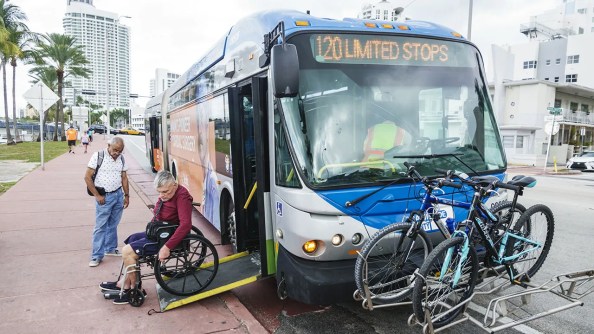 A bus passenger in Miami Beach, Florida, uses a handicapped access ramp. (Jeffrey Greenberg/Education Images/Universal Images Group via Getty Images)