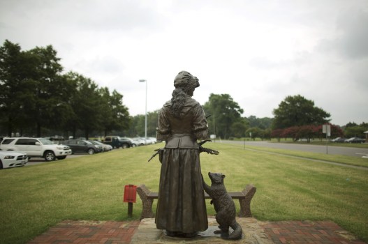 A statue of Grace Sherwood stands across the street from Old Donation Church on the corner of Witchduck Road and Independence Blvd. (L. Todd Spencer/The Virginian-Pilot)