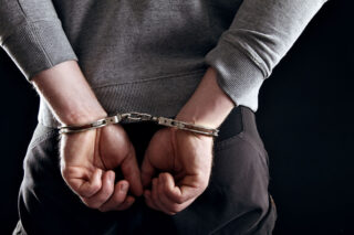 photo - Hands Locked in Handcuffs