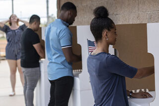 photo - People Voting and Waiting in Line to Vote