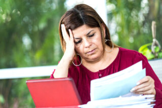 photo - Worried Woman Looking at Bills