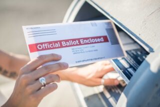 photo - Woman Mailing her Ballot