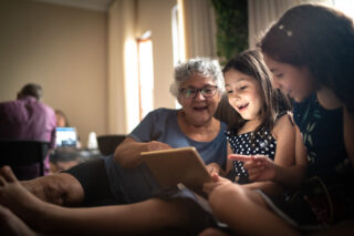 photo - Grandmother and Granddaughter on a Video Call with a Digital Tablet