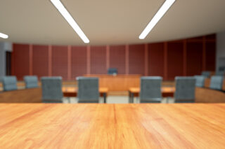 photo - Empty Courtroom Interior with Wooden Desk and Blurred Background