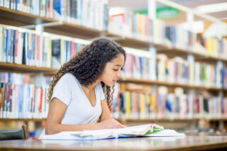 photo - Female Student Studying in Library