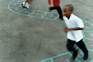 photo - Primary School Children Chasing Each Other in a School Playground