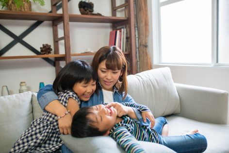 Mother playing with her children at home