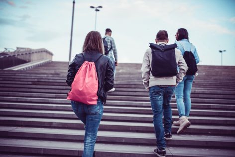 Group of Students with Backpacks Walking to School