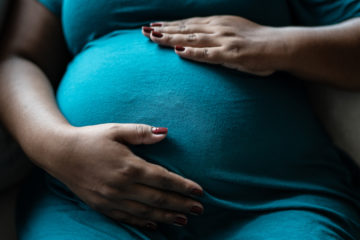 Pregnant woman touching her belly