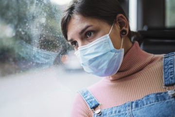 Woman Travelling In Bus And Wearing A Face Mask