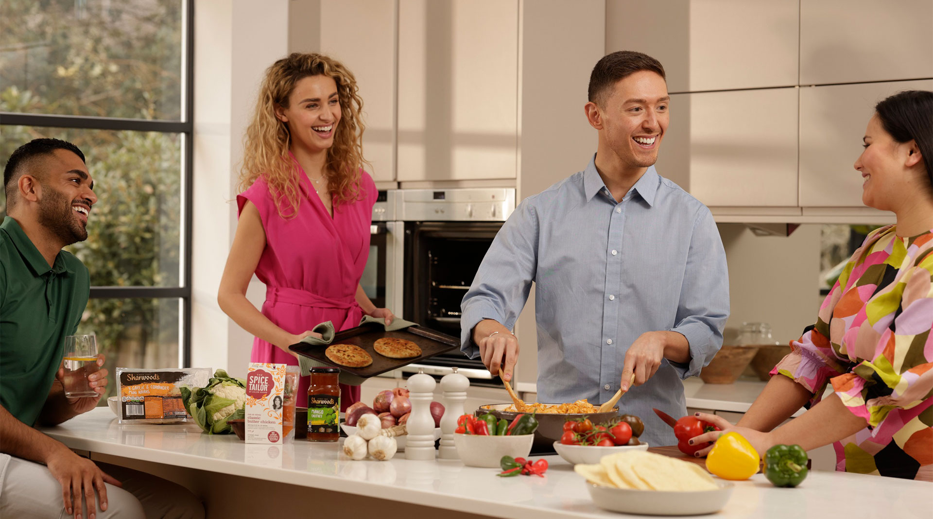 4 people cooking in a kitchen, plus brand placement