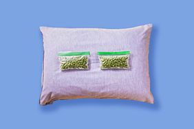 purple pillow with two baggies of peas on a blue background