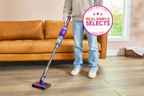 A person using the Omni Glide Vacuum on a wooden floor