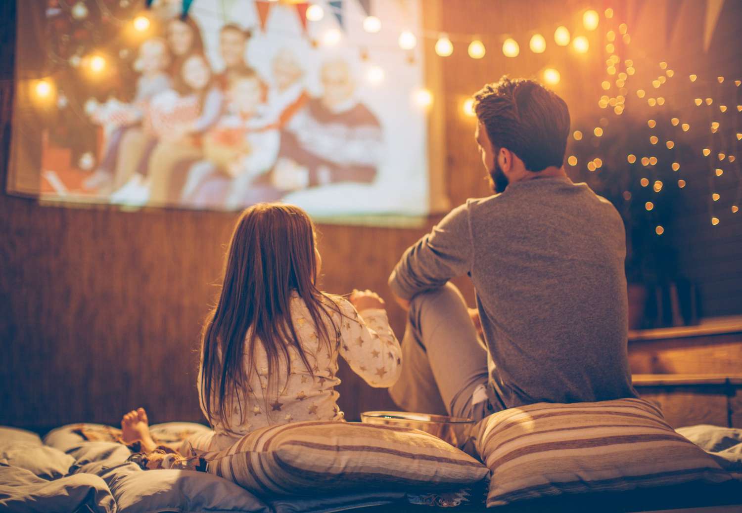 Father and daughter watching an outdoor movie