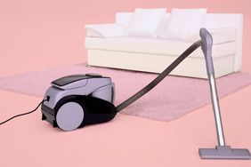 image of a vacuum and a couch: how to clean a couch