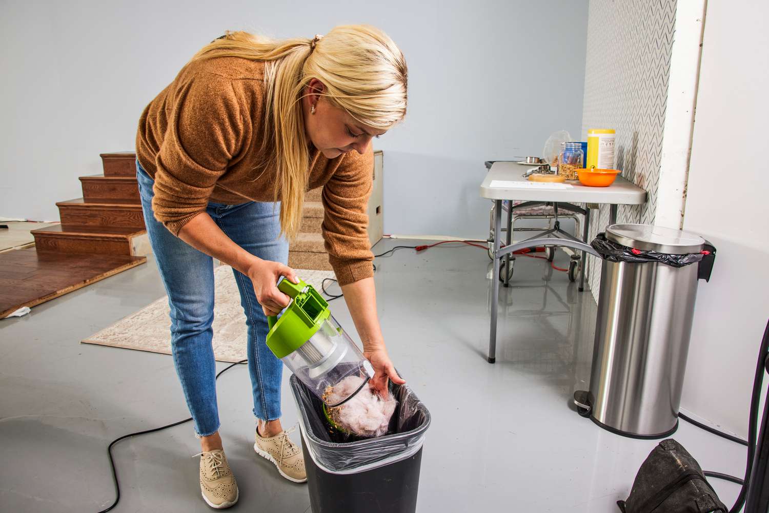 A person empies the Bissell Zing Bagless Canister Vacuum, 2156A