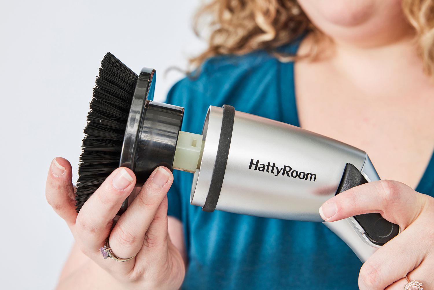 Person holds the head of a HattyRoom Rechargeable Cordless Electric Spin Scrubber