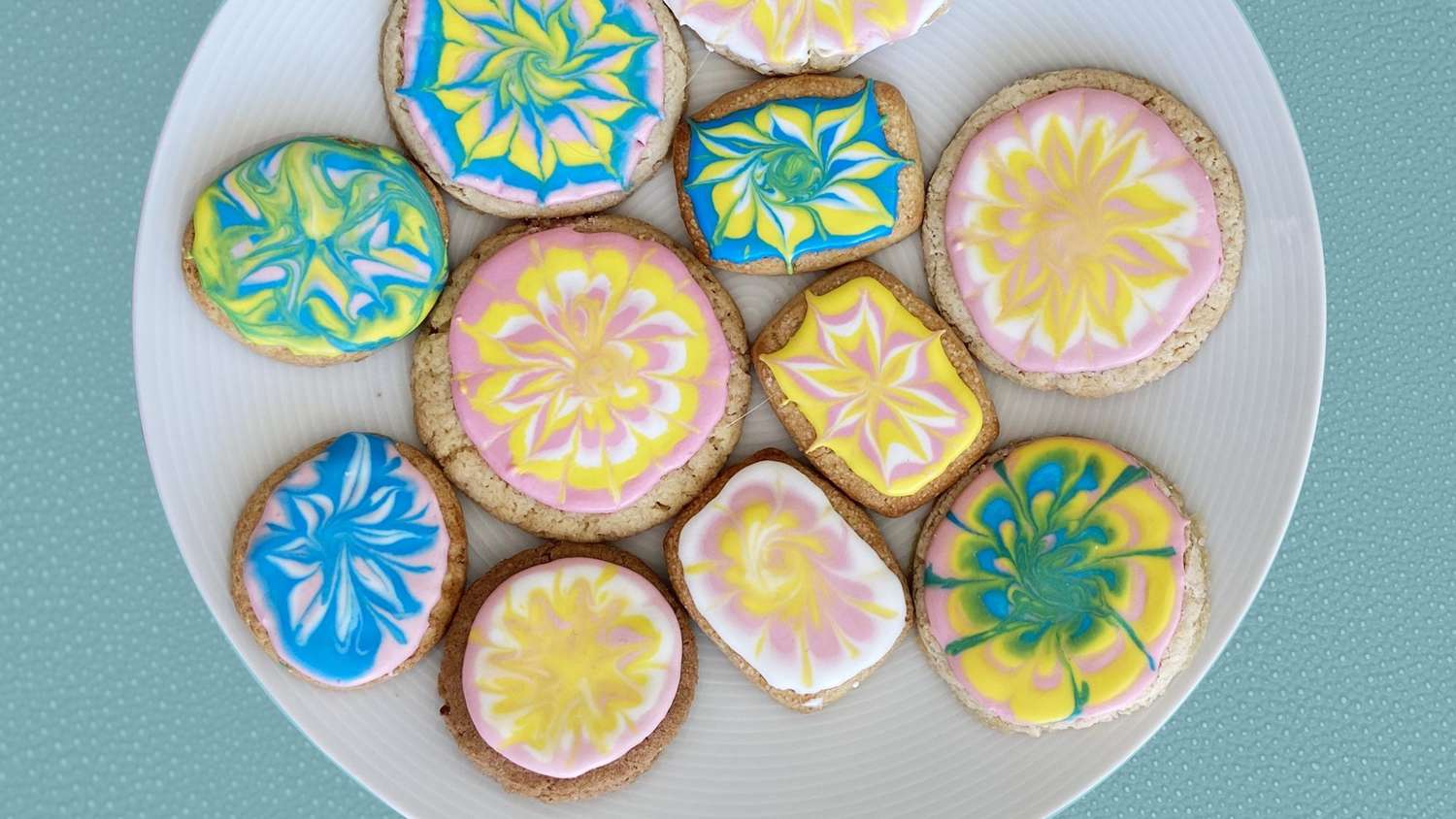 Tie dye sugar cookies displayed on a serving platter.