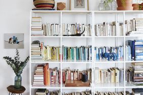 White bookshelves arranged by color