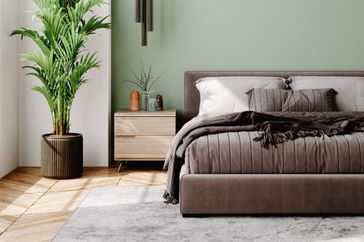 Interior of a modern bedroom decorated with modern furniture with pastel tones.