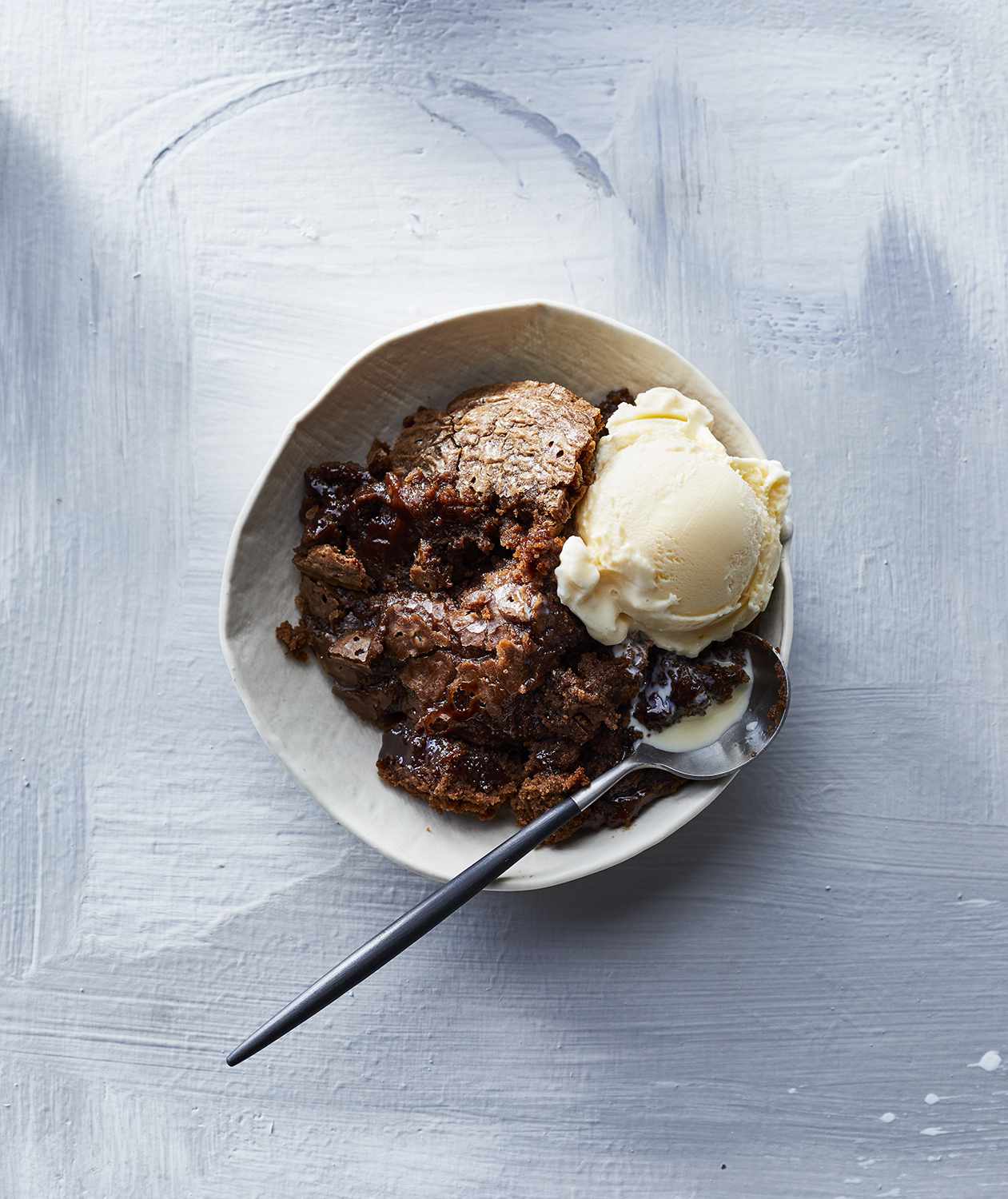 Slow-Cooker Chocolate Pudding Cake served with ice cream on a plate.