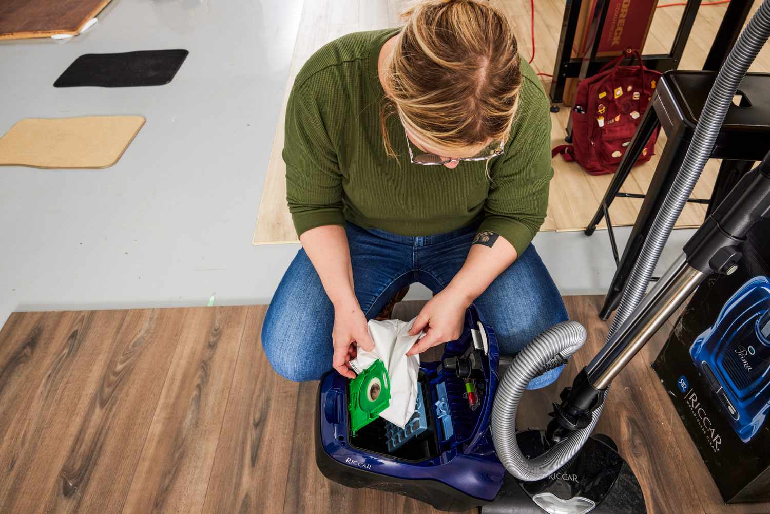 A person places a bag in the Riccar Prima Power Team with Full-Size Nozzle R50FSN.4 Vacuum