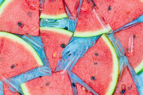 close up of watermelon slices sitting on ice
