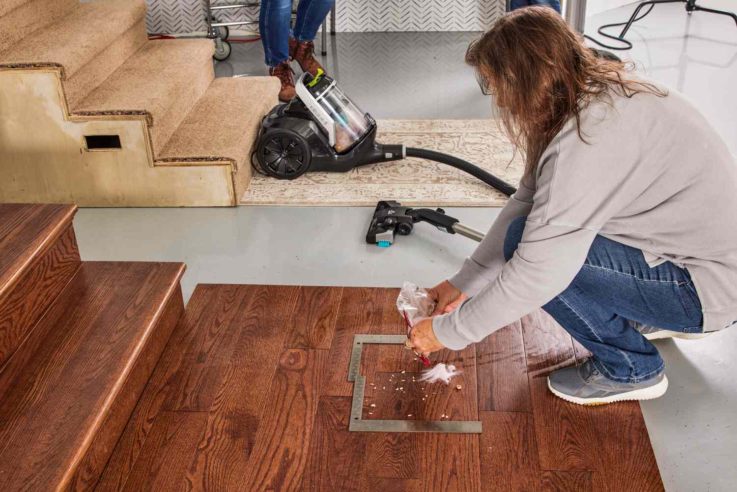 A person prepares to vacuum using the Bissell SmartClean Canister Vacuum