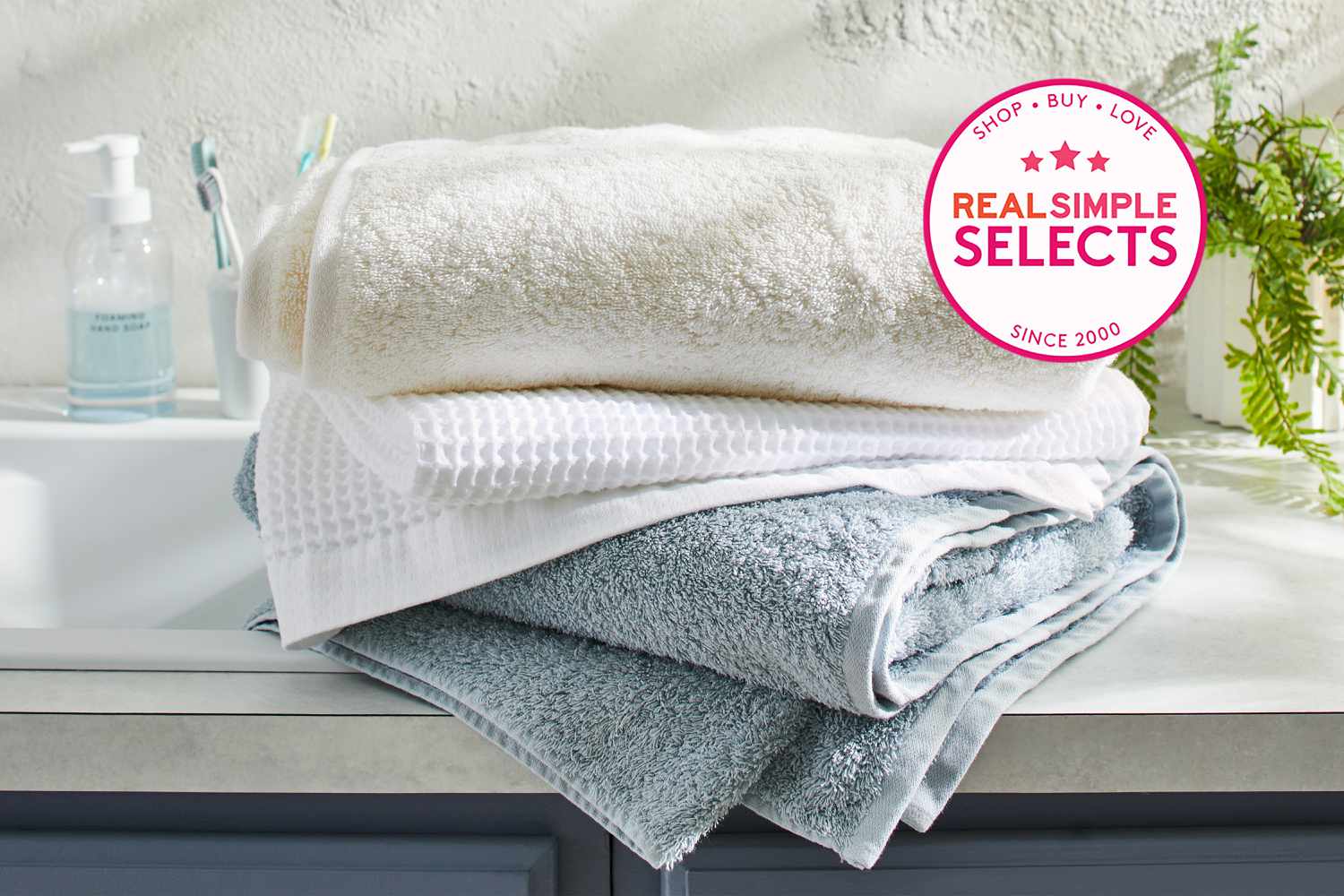 A selection of some of the best bath towels stacked on a counter