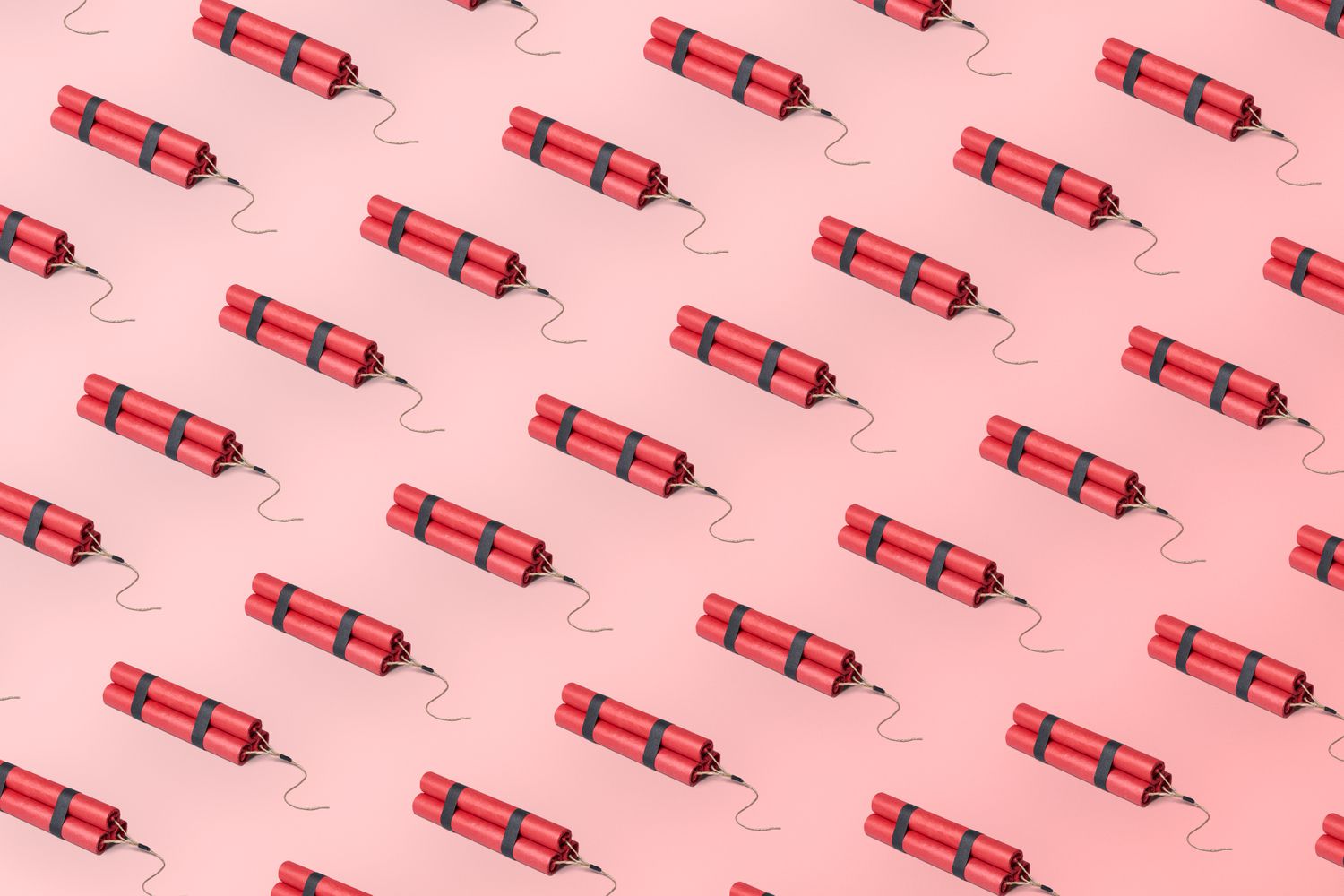 A group of dynamite stick evenly spaced out in a grid pattern on a pastel pink background with a gradient. Image is in a graphic and light-hearted style.