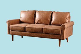 An affordable brown leather couch on a blue background.