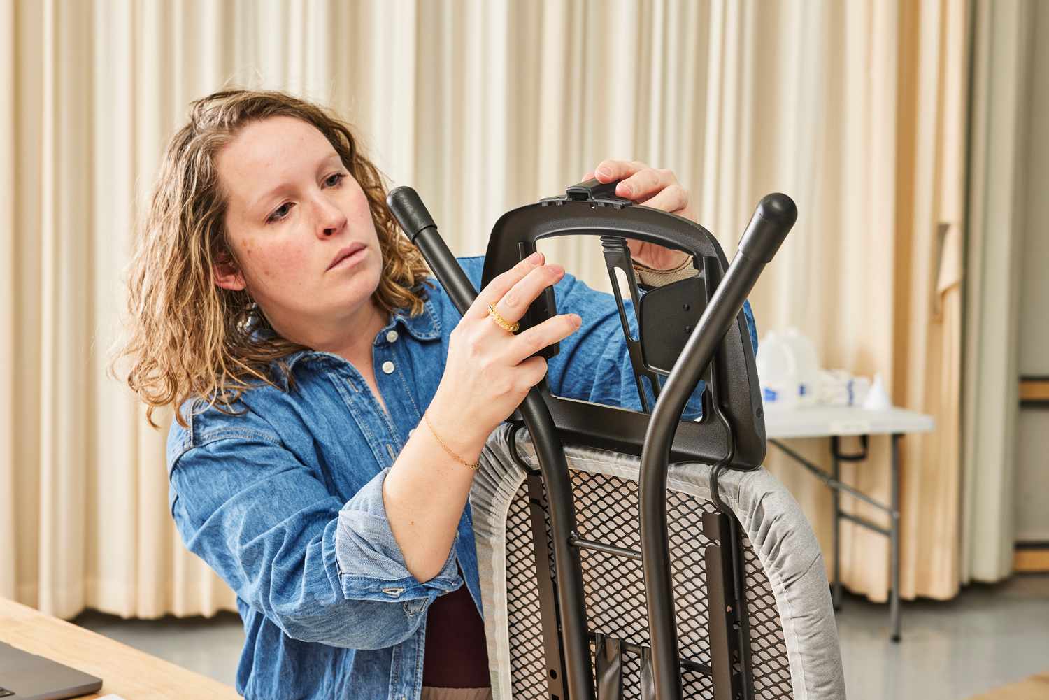 A person assembling the Bartnelli Heavy Duty Ironing Board