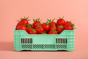 What are nightshade vegetables: crate of tomatoes on a peach background