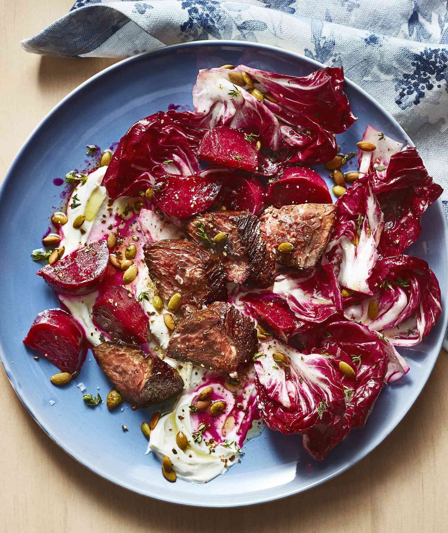 Steak and beet salad displayed on a plate.