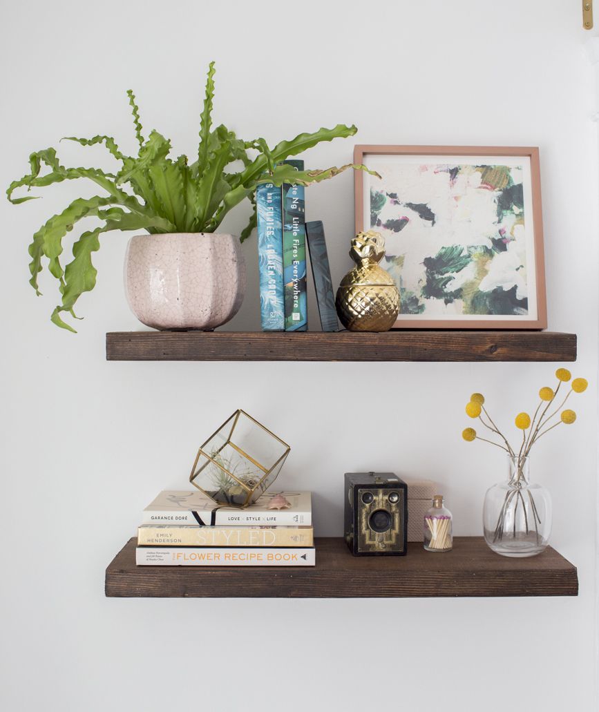 DIY floating shelves with plant, artwork, books