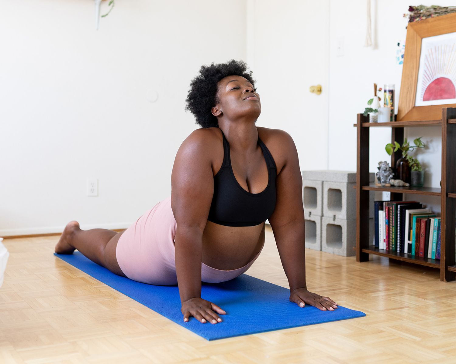 Restorative Yoga: woman doing upward dog yoga pose at home