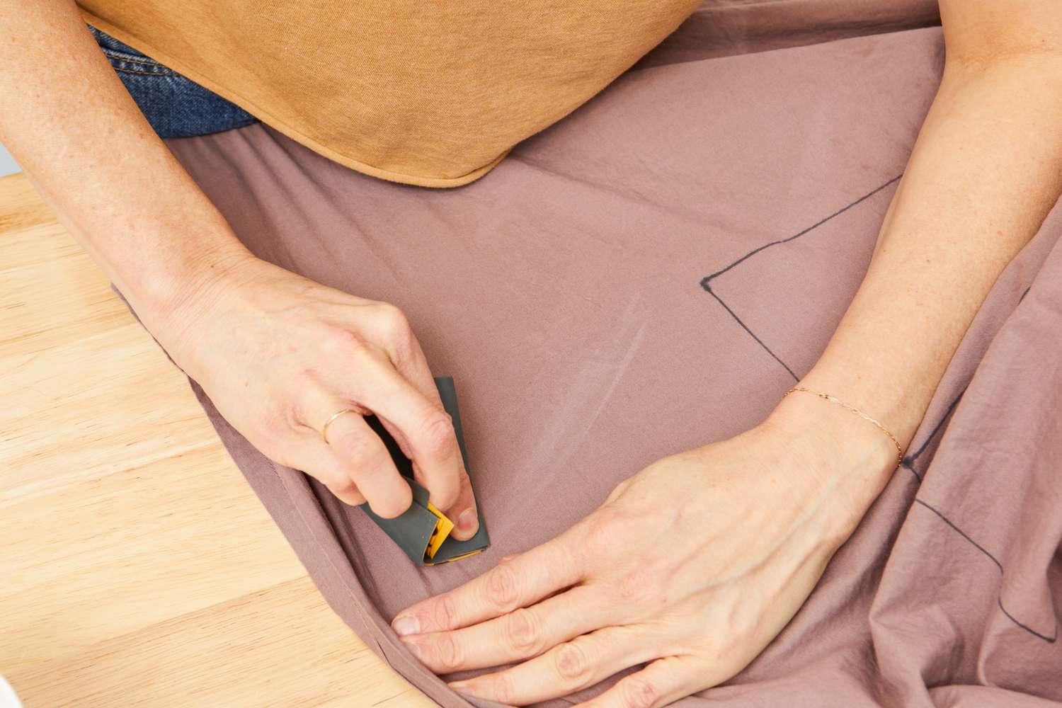 Person marking on Parachute Brushed Cotton Sheet Set on a table 