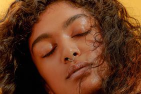 Portrait of a Young Confident Woman Closing her Eyes with Windswept Hair